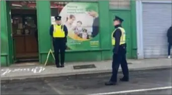  ??  ?? Newly attested Gardai Michelle Connolly and Garda Niall Mc Gill out on the beat on Castle Street in Sligo ensuring people are adhering to physical distancing when queuing outside the post office.