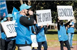  ?? JACQUELYN MARTIN/AP ?? Members of the Uyghur American Associatio­n rally in October by the White House.