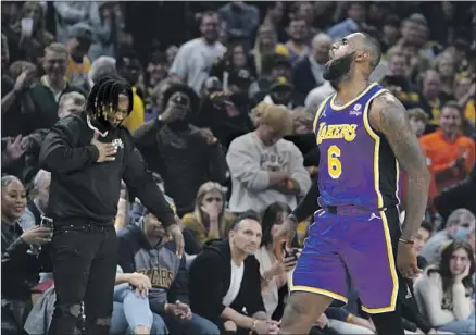  ?? Darron Cummings Associated Press ?? LeBRON JAMES reacts after hitting a shot during overtime of the Lakers’ 124-116 victory over the Indiana Pacers on Wednesday. James finished with 39 points, five rebounds and six assists in his first game back from a one-game suspension.