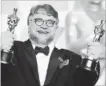  ?? JORDAN STRAUSS THE ASSOCIATED PRESS ?? Guillermo del Toro celebrates his Oscar wins for best director and best picture.