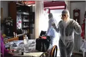  ?? CLAUDIO FURLAN — LAPRESSE VIA AP ?? Medical staffers wearing protective gear, part of a special unit performing house calls, work in Bergamo in northern Italy, one of the areas worst affected by the coronaviru­s.