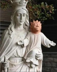  ?? GINO DONATO, THE CANADIAN PRESS ?? A statue of baby Jesus in Sudbury got a facelift after it was vandalized. Parishione­rs find the orange clay head jarring, says the church’s priest.