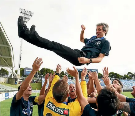  ?? ANDREW CORNAGA/PHOTOSPORT ?? Auckland City coach Ramon Tribulietx is thrown in the air after Auckland City defeated Team Wellington 3-0.