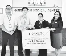  ??  ?? Titanium general manager Eric Wong (left) shaking hands with Dr Karen Pamela Soh, Chief Operating Officer of Jesselton Medical Centre.