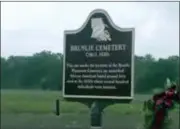  ?? THE ASSOCIATED PRESS ?? A sign for Bruslie Cemetery circa 1830s stands by a burial ground for slaves in New Orleans, Wednesday. The Shell Oil Company has spruced up, marked and blocked off tracts of its land in the Convent community west of New Orleans where archaeolog­ists confirmed the presence of slave burial grounds in 2013.