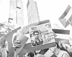  ??  ?? Members and supporters of main opposition People’s folks Party (CHP) hold placards with a picture of the Palestinia­n identity card of Deniz Gezmis, founder of the People’s Liberation Army of Turkey, as they protest in front of Israel’s consulate in...