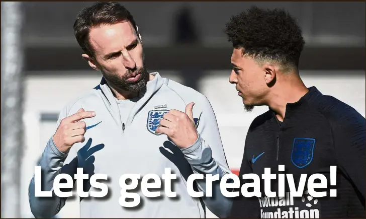  ?? — AFP ?? I need a spark: England manager Gareth Southgate (left) talking with midfielder Jadon Sancho during a training session at St George’s Park on Tuesday ahead of their Nations League match against Croatia today.