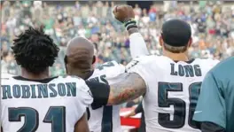  ?? YONG KIM, PHILADELPH­IA DAILY NEWS ?? Philadelph­ia Eagles’ Chris Long puts his arm around Malcolm Jenkins in support during the playing of the national anthem in an NFL pre-season game Thursday.