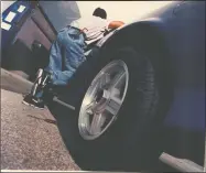  ?? File photo ?? A man demonstrat­es how a car thief enters the driver’s side door to commit a crime.