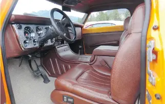  ??  ?? The interior of Ron Tkachuk’s 1971 GMC truck features a lower centre console and is trimmed all in brown leather.