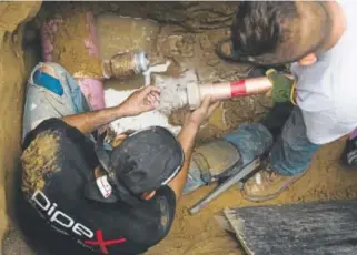  ?? Gabriel Scarlett, The Denver Post ?? Workers on Wednesday install purple pipes for nonpotable, recycled water for irrigation in Denver. Informally dubbed the “Purple Pipes Project,” such use of nonpotable water for irrigation would save the city money.