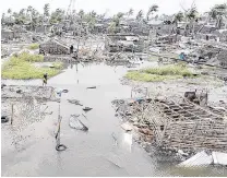  ?? PHOTOS: AP ?? Flooded and razed . . . An aerial view of the destructio­n.