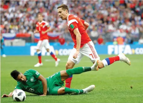  ?? Reuters ?? Russia’s Daler Kuzyayev gets the better of Saudi Arabia’s Salem Al Dawsari during the opening match. —