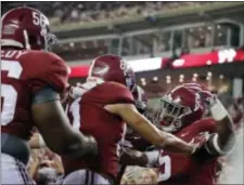  ?? BRYNN ANDERSON — THE ASSOCIATED PRESS ?? Alabama offensive lineman Brandon Kennedy, wide receiver Derek Kief and tight end Ronnie Clark, right, celebrate after Clark scores a touchdown during the second half of an NCAA college football game Mississipp­i, Saturday in Tuscaloosa, Ala.