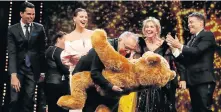  ?? Picture: HANNIBAL HANSCHKE/REUTERS ?? BEAR TRUTH: Outgoing festival director Dieter Kosslick receives a Bear award from internatio­nal jury president Juliette Binoche at the Berlin Film Festival