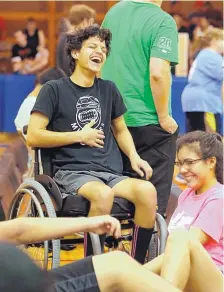  ?? CHARLES REX ARBOGAST/ASSOCIATED PRESS ?? Jonathan Annicks, left, laughs with his girlfriend Cynthia Valentin during an indoor field hockey game in Berwyn, Ill., in June.