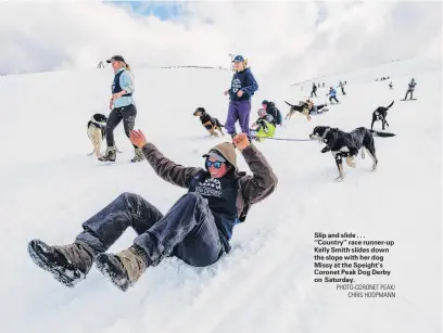  ?? PHOTOCORON­ET PEAK/
CHRIS HOOPMANN ?? Slip and slide . . . ‘‘Country’’ race runnerup Kelly Smith slides down the slope with her dog Missy at the Speight’s Coronet Peak Dog Derby on Saturday.