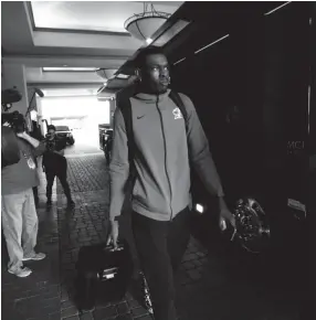  ?? JOE RONDONE/THE COMMERCIAL APPEAL ?? Memphis basketball player Lance Thomas prepares to leave the team’s hotel in Fort Worth, Texas, after AAC officials officially canceled the conference tournament Thursday.