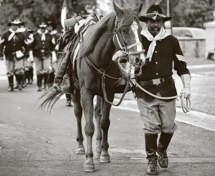  ?? Bob Owen / Staff file photo ?? Bobby Ray Carter of the Bexar County Buffalo Soldiers leads a horse honoring the Missing Soldier during a ceremony last year.