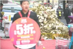  ?? — Reuters photo ?? Durian husks are seen outside a fruit store during a Double 12 shopping festival sale, in Hangzhou, Zhejiang province, China.