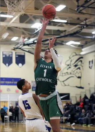  ?? RANDY MEYERS — FOR THE MORNING JOURNAL ?? Jarred Logan of Elyria Catholic avoids the charge into Jalen Knott of Lutheran East on the shot during the district finals on March 8.