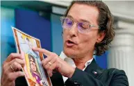  ?? ?? Plea: Hollywood star Matthew McConaughe­y holds a picture drawn by one of the victims