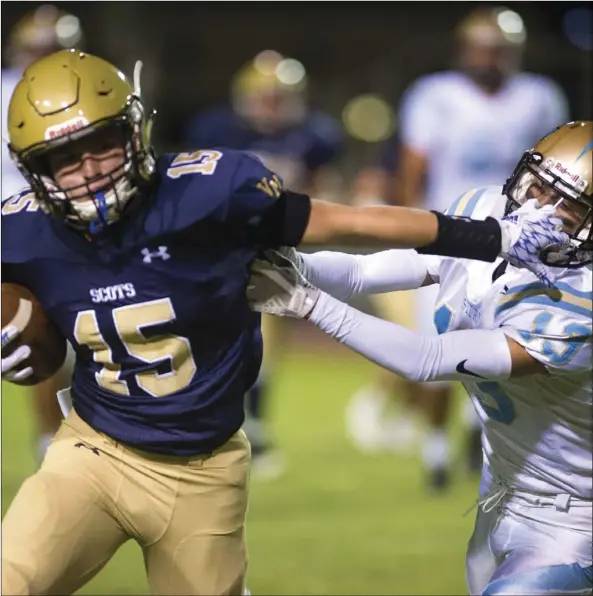  ?? VINCENT OSUNA PHOTO ?? Vincent Memorial High School wide receiver Juan Pablo Ruiz performs a stiff arm move on a defender during their home game against San Ysidro High School on Friday night in El Centro.