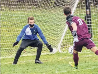  ?? James Franco / Special to the Times Union ?? Greenville senior James Mitchell gets one by Maple Hill keeper Logan Mcgarvey during their Patroon Conference matchup Saturday at Greenville High School.