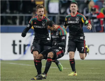  ??  ?? Juninho ( 19) of the Los Angeles Galaxy celebrates with teammates after scoring against the Seattle Sounders during the Western Conference fi nal in Seattle. Last year’s MLS Cup fi nal drew just over 500,000 TV viewers in North America.