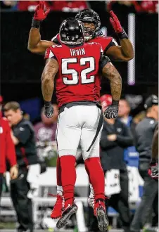  ?? ALYSSA POINTER / ALYSSA. POINTER@AJC. COM ?? Falcons defensive ends Bruce Irvin and Steven Means celebrate a firsthalf play against the Cardinals earlier this month. Irvin, a free agent at season’s end, has been exactly the pass rusher the Falcons envisioned when they brought him home. He has at least one sack in three straight games.