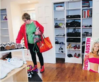  ??  ?? Carter Flemming, 65, checks out exercise equipment at an estate sale at the home of fitness guru Denise Austin.