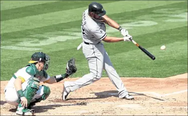  ?? EZRASHAW / Getty Images ?? White Sox first baseman Jose Abreu, right, hits a two-run home run Tuesday against the Athletics in Game 1 of their American League wild-card series at Ringcentra­l Coliseum in Oakland, Calif.