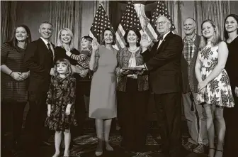  ?? Associated Press file photo ?? Rep. Ron Wright, R-Arlington, fourth from right, gets sworn in to office in January 2019 by House Speaker Nancy Pelosi. Wright, who had lung cancer, died Sunday after contractin­g COVID-19.