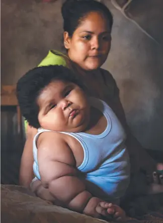  ?? Picture: AFP ?? Ten-month-old Luis Gonzales and his concerned mother Isabel Pantoja, 24, at their home in Mexico. The baby weighs a whopping 28kg.