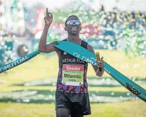  ?? / RAJESH JANTILAL/ AFP ?? Bong’musa Mthembu reacts after crossing the finish line to win the Comrades Marathon on Sunday.