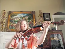  ?? ROSE BACA/TRIBUNE NEWS SERVICE ?? Rebecca Glass, blind since birth, plays her viola at her home in Plano, Texas. “If I were to define myself with what I do it would be: ‘I am a musician,’ ” she said.