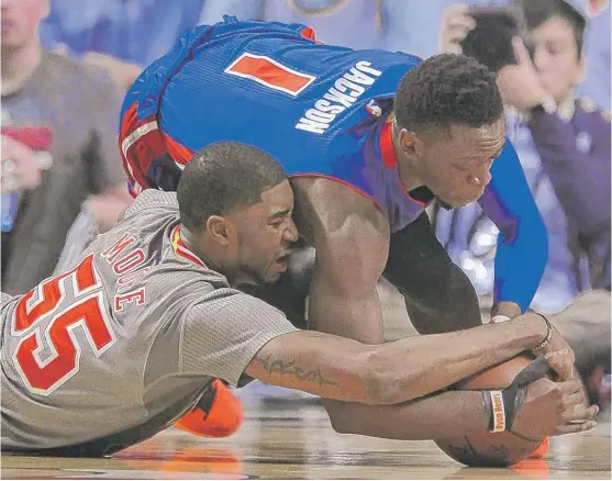  ?? | PAUL BEATY/AP ?? Bulls guard E’Twaun Moore (left), who had eight points, battles with Pistons guard Reggie Jackson for a loose ball in the first half Saturday at the United Center.