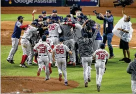  ?? TIM WARNER / GETTY IMAGES ?? Red Sox players celebrate after defeating the Astros to win the American League Championsh­ip Series on Thursday in Houston. Boston will host Game 1 of the World Series on Tuesday.