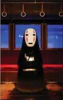  ?? ?? No Face, a character from the Oscarwinni­ng 2001 Studio Ghibli film “Spirited Away,” sits in a re-creation of a train car.