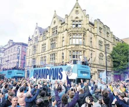  ?? AP ?? Manchester City’s players pass by on an open top bus as fans watch the winners parade as the team celebrates winning the English Premier League title in Manchester, England, yesterday.