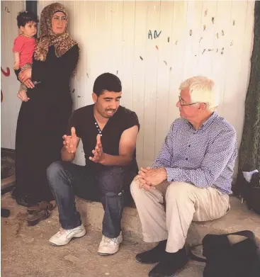  ??  ?? CAMPAIGN: Human rights and refugee lawyer and advocate Julian Burnside talking to Syrian refugees in a Jordanian refugee camp.