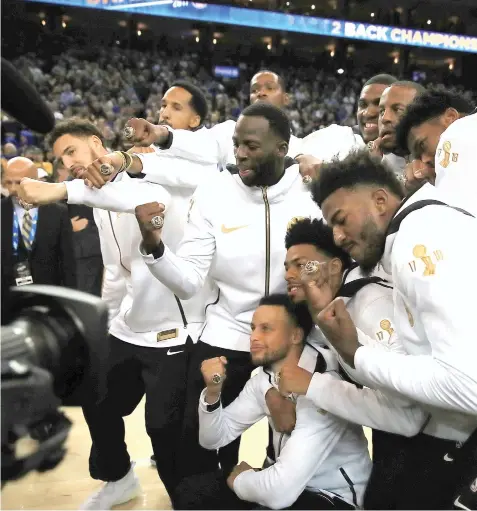  ?? ASSOCIATED PRESS ?? The Golden State Warriors celebrate after receiving their championsh­ip rings after an awards ceremony to recognize the team's NBA championsh­ip prior to a basketball game against the Oklahoma City Thunder, Tuesday, Oct. 16, 2018, in Oakland, Calif.