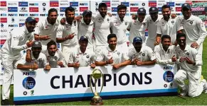 ?? — AFP ?? Deserving winners: The Indian team posing with the Border- Gavaskar trophy after winning the fourth and final Test against Australia in Dharamsala, India, yesterday.