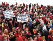  ?? — Via Web ?? Protesters hold posters at Sydney's Bondi Beach in Australia on Saturday against Indian miner Adani’s planned coal mine project. Environmen­t groups say the mine in Queensland state would contribute to global warming and damage the Great Barrier Reef....