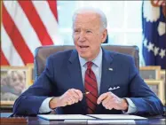  ?? AP-Evan Vucci, File ?? In this Jan. 28 file photo, President Joe Biden signs a series of executive orders in the Oval Office of the White House in Washington. Biden campaigned on raising the national minimum wage to $15 per hour and attached a proposal doing just that to the $1.9 trillion coronaviru­s pandemic relief bill.