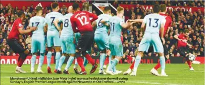  ??  ?? P W D L F A Pts Manchester United midfielder Juan Mata (right) scores a freekick over the wall during Sunday’s English Premier League match against Newcastle at Old Trafford. –