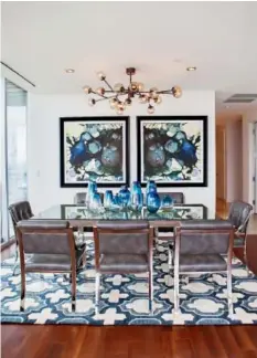  ??  ?? Comfort is just as important as beauty when selecting dining room seating, says Abbe Fenimore, who chose sleek padded chairs for this dining room.