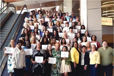  ?? The Sentinel-Record/Donald Cross ?? The 2022 recipients of Oaklawn Foundation Scholarshi­ps and members of the foundation gather for a photo Thursday following the annual awards ceremony at Oaklawn Racing Casino Resort’s Event Center.