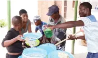  ?? ?? Children living and working on the streets wash plates after a meal prepared by First Lady Dr Auxillia Mnangagwa at the skills developmen­t centre in Mbare yesterday