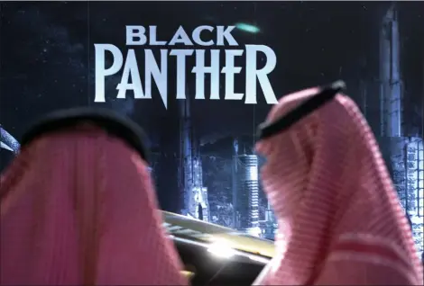  ?? AMR NABIL — THE ASSOCIATED PRESS ?? Visitors wait in front of a “Black Panther” movie banner, during an invitation-only screening, at the King Abdullah Financial District Theater, in Riyadh, Saudi Arabia, Wednesday. Saudi Arabia held a private screening of the Hollywood blockbuste­r...